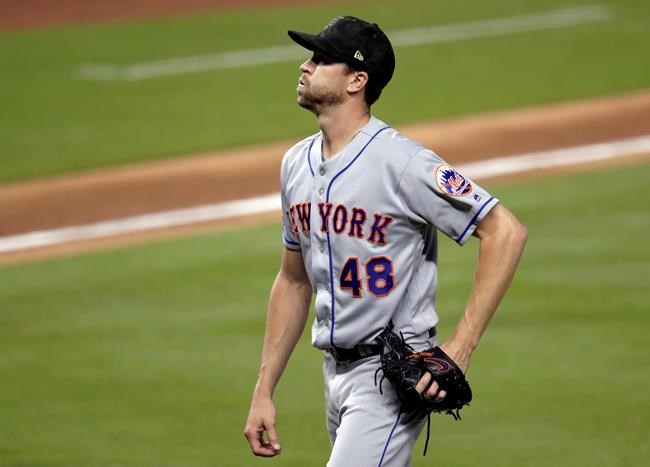 New York Mets starting pitcher Jacob deGrom walks to the dugout after pitching during the third inning of the team's baseball game against the Miami Marlins, Friday, May 17, 2019, in Miami. The Marlins scored two runs in the inning. (AP Photo/Lynne Sladky)