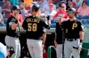 Pittsburgh Pirates' Jacob Stallings (58) is congratulated by Will Craig, left, and Lonnie Chisenhall (5) after hitting a two-run home run in the fifth inning during a spring training baseball game against the Philadelphia Phillies, Friday, March 1, 2019, in Clearwater, Fla. (AP Photo/Lynne Sladky)