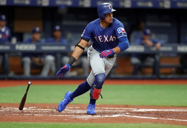 Texas Rangers' Ronald Guzman drops his bat after hitting a two-run double against the Tampa Bay Rays during the second inning of a baseball game Friday, June 28, 2019, in St. Petersburg, Fla. (AP Photo/Mike Carlson)