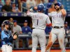 Texas Rangers' Joey Gallo, right, celebrates his home run with Elvis Andrus as Tampa Bay Rays' Travis d'Arnaud, left, looks on during the fourth inning of a baseball game Sunday, June 30, 2019, in St. Petersburg, Fla. (AP Photo/Mike Carlson)