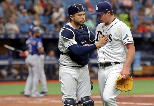 Tampa Bay Rays catcher Travis d'Arnaud congratulates starting pitcher Brendan McKay after striking out Texas Rangers' Delino DeShields during the sixth inning of a baseball game Saturday, June 29, 2019, in St. Petersburg, Fla. (AP Photo/Mike Carlson)