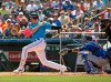 Miami Marlins' Brian Anderson (15) hits a single during the first inning against the New York Mets during a spring training baseball game, Tuesday, March 12, 2019, in Jupiter, Fla. (David Santiago/Miami Herald via AP)