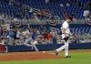 Miami Marlins pitcher Trevor Richards (36) looks down as New York Mets pitcher Jacob deGrom rounds the bases after hitting a solo home run during the third inning of baseball game in Miami, Wednesday, April 3, 2019. (David Santiago/Miami Herald via AP)