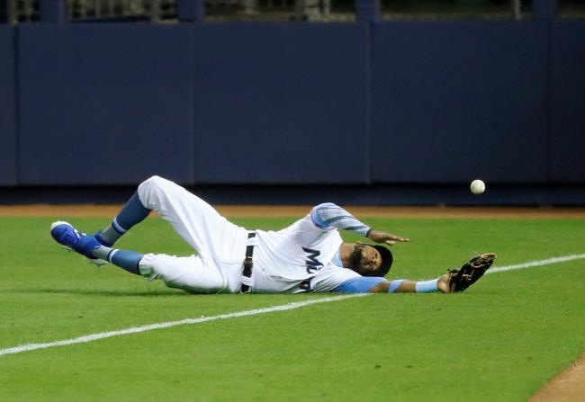 Miami Marlins right fielder Rosell Herrera is unable to catch a ball hit by Pittsburgh Pirates' Kevin Newman for a double during the first inning of a baseball game, Sunday, June 16, 2019, in Miami. (AP Photo/Wilfredo Lee)