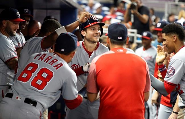 Washington Nationals' Trea Turner, center, is congratulated by teammates after Turner hit a three-run home run during the fourth inning of the team's baseball game against the Miami Marlins, Tuesday, June 25, 2019, in Miami. (AP Photo/Wilfredo Lee)