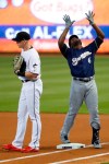 Milwaukee Brewers' Lorenzo Cain (6) celebrates a base hit next to Miami Marlins right fielder Garrett Cooper during the first inning of a baseball game, Thursday, Sept. 12, 2019, in Miami. (AP Photo/Wilfredo Lee)