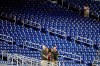 Baseball fans stand among empty seats during the singing of the national anthem before a baseball game between the Miami Marlins and the Milwaukee Brewers, Monday, Sept. 9, 2019, in Miami. (AP Photo/Wilfredo Lee)