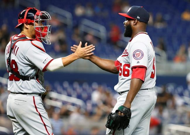 Washington Nationals relief pitcher Fernando Rodney (56) and catcher Kurt Suzuki congratulate each other after the Nationals defeated the Miami Marlins 6-1 during a baseball game Tuesday, June 25, 2019, in Miami. (AP Photo/Wilfredo Lee)