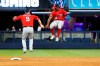 Washington Nationals' Brian Dozier (9) and Victor Robles (16) celebrate after they defeated the Miami Marlins in 10 innings of a baseball game Saturday, Sept. 21, 2019, in Miami. (AP Photo/Wilfredo Lee)