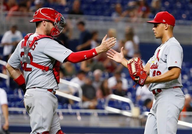 St. Louis Cardinals relief pitcher Jordan Hicks, right, and catcher Matt Wieters congratulate each other after they defeated the Miami Marlins in a baseball game, Monday, June 10, 2019, in Miami. (AP Photo/Wilfredo Lee)