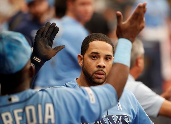 Tampa Bay Rays Tommy Pham celebrates in the dug out after hitting a home run against the Los Angeles Angels during the fifth inning of a baseball game Sunday, June 16, 2019, in St. Petersburg, Fla. (AP Photo/Scott Audette)