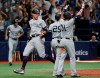 New York Yankees' Aaron Judge, left, celebrates with teammates after scoring during the 10th inning of a baseball game against the Tampa Bay Rays on Thursday, July 4, 2019, in St. Petersburg, Fla. (AP Photo/Scott Audette)