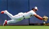 Washington Nationals right fielder Chuck Taylor dives but is unable to catch a ball hit for a single by Houston Astros' Carlos Correa during the first inning of an exhibition spring training baseball game Sunday, March 3, 2019, in West Palm Beach, Fla. (AP Photo/Jeff Roberson)