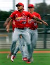 St. Louis Cardinals pitcher Carlos Martinez (18) warms up with his teammates during spring training baseball practice Wednesday, Feb. 13, 2019, in Jupiter, Fla. (AP Photo/Jeff Roberson)
