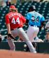 Washington Nationals pitcher Trevor Rosenthal (44) drops the ball as he is beaten to the bag on a single by Miami Marlins' Magneuris Sierra (34) during the third inning of an exhibition spring training baseball game Friday, March 1, 2019, in Jupiter, Fla. (AP Photo/Jeff Roberson)