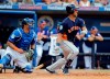 Houston Astros' Michael Brantley, right, hits an RBI single as New York Mets catcher Wilson Ramos watches during the fifth inning of an exhibition spring training baseball game Saturday, March 2, 2019, in Port St. Lucie, Fla. (AP Photo/Jeff Roberson)