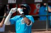 Miami Marlins' Lewis Brinson looks skyward as he arrives home after hitting a solo home run during the fifth inning of an exhibition spring training baseball game against the Washington Nationals Monday, March 4, 2019, in Jupiter, Fla. The home run was the second of the game for Brinson. (AP Photo/Jeff Roberson)
