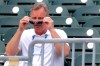 Gary Denbo puts on sunglasses as he sits in the stands at Roger Dean Stadium before the start of an exhibition spring training baseball game between the Miami Marlins and the Washington Nationals Friday, March 1, 2019, in Jupiter, Fla. A bond between two Yankees formed in early 1990s when Gary Denbo became Derek Jeter‚Äôs mentor. Now they‚Äôve changed teams and are trying to lead the Miami Marlins out of the wilderness, with Denbo playing a key role as vice president of scouting and player development. (AP Photo/Jeff Roberson)