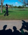 The shadows of golf fans are cast on the cart path as Justin Thomas hits from out of bounds on the ninth hole during the third round of the Honda Classic golf tournament, Saturday, March 2, 2019, in Palm Beach Gardens, Fla. (AP Photo/Wilfredo Lee)
