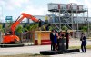 Soccer commentator Fernando Fiore, far right, counts down as dignitaries from the city and Inter Miami CF press a button to signal an excavator to start knocking down an old ticket booth during a demolition ceremony at the old Lockhart Stadium, Wednesday, May 8, 2019, in Fort Lauderdale, Fla. A new stadium will be built at that site and will serve as the temporary home for Inter Miami CF while its permanent stadium is built at Freedom Park in Miami. (AP Photo/Wilfredo Lee)