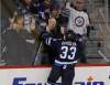 WINNIPEG FREE PRESS
Winnipeg Jets' Dustin Byfuglien (33) pounds on the glass after scoring against the Philadelphia Flyers' during first period NHL action on Tuesday.