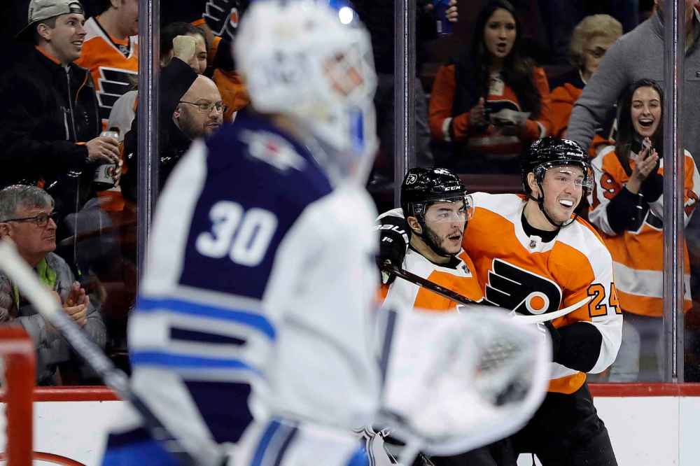 (AP Photo/Matt Slocum)
Philadelphia Flyers' Phil Varone, centre, celebrates with Mikhail Vorobyev, right, after scoring a goal on Winnipeg Jets' Laurent Brossoit during the second period Monday in Philadelphia.