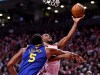 Toronto Raptors forward Kawhi Leonard (2) scores over Golden State Warriors centre Kevon Looney (5) during second half basketball action in Game 1 of the NBA Finals in Toronto on Thursday, May 30, 2019. THE CANADIAN PRESS/Frank Gunn