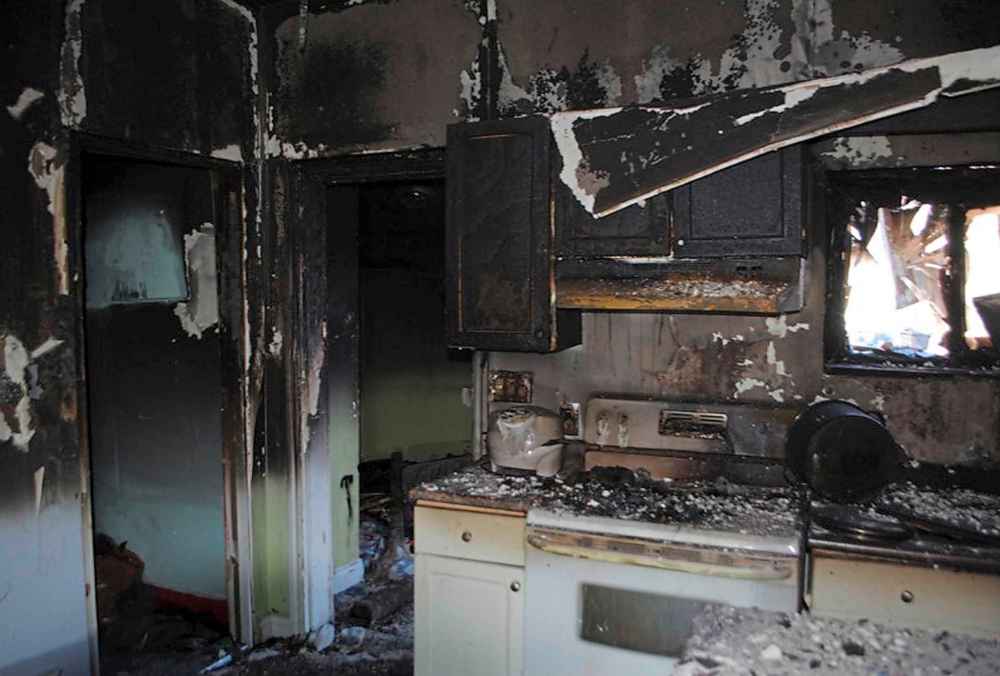 A photo from the trial shows the kitchen of the Jeanenne Fontaine's Aberdeen Avenue home after the fire. Fontaine's brother Chuck testified he saw a man turn on the stovetop and pile it with clothes. (Winnipeg Free Press)