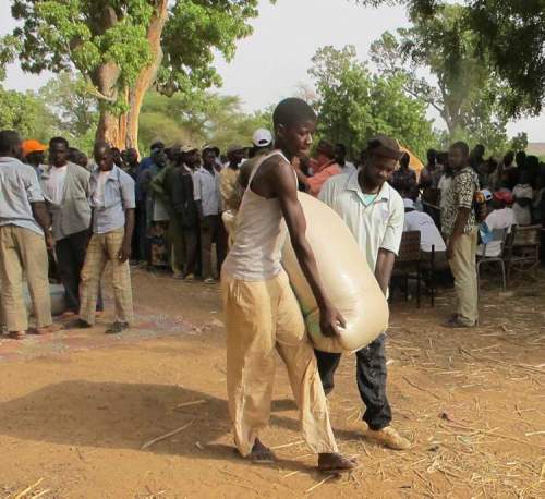 photos by bartley kives / winnipeg free press
Men carry a 100-kilogram bag of millet as they leave a distribution centre in western Niger.