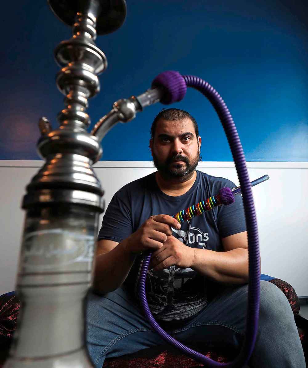 RUTH BONNEVILLE / WINNIPEG FREE PRESS
Ali Baba restaurant chef, Sinan Aboud with his rainbow-coloured pipe he spotted in a shop Jordan when he was last there. He saw it and thought of getting it for Pride Week, which runs through Sunday in Winnipeg. His restaurant opened earlier this month and offers hookah pipes and 22 flavoured herbs to smoke.