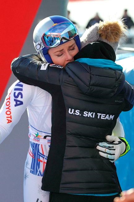 FILE - In this Sunday, Jan. 20, 2019 file photo, United States' Lindsey Vonn hugs a US team staffer in the finish area of an alpine ski, women's World Cup super-G in Cortina D'Ampezzo, Italy. It seemed like destiny played a role on Sunday when Mikaela Shiffrin won what could very well turn out to be Lindsey Vonn's last race. Vonn broke down emotionally after she failed to finish a World Cup super-G on knees so worn down that she describes them as