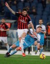 FILE - In this Tuesday, Feb.26, 2019 filer, Lazio's Sergej Milinkovic-Savic, right is tackled by AC Milan's Alessio Romagnoli during the Italian Cup, first leg semifinal soccer match between Lazio and AC Milan at the Olympic stadium in Rome. Still smarting from controversial refereeing decisions and troubled by impending new financial fair play sanctions, AC Milan faces one of its most crucial matches of the season. Milan hosts Lazio on Saturday in a match that could prove fundamental to both teams' Champions League hopes. Milan currently occupies fourth spot and the final Champions League berth but it is above Atalanta only on head-to-head record. Seventh-place Lazio is three points below Milan, but has played a match less. (AP Photo/Gregorio Borgia, File)