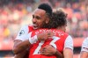 Arsenal's David Luiz celebrates with his teammate Pierre-Emerick Aubameyang, left, after scoring his side's opening goalduring the English Premier League soccer match between Arsenal and Bournemouth at the Emirates stadium in London, Sunday, Oct. 6, 2019. (AP Photo/Leila Coker)