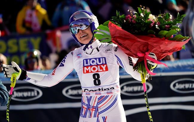 United States' Lindsey Vonn holds a bunch of flowers she was given after completing an alpine ski, women's World Cup super-G in Cortina D'Ampezzo, Italy, Sunday, Jan. 20, 2019. (AP Photo/Giovanni Auletta)