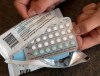 FILE - In this Aug. 26, 2016, file photo, a one-month dosage of hormonal birth control pills is displayed in Sacramento, Calif. A U.S. appeals court Thursday, Dec. 13, 2018, blocked rules by the Trump administration allowing more employers to opt out of providing women with no-cost birth control. (AP Photo/Rich Pedroncelli, File)