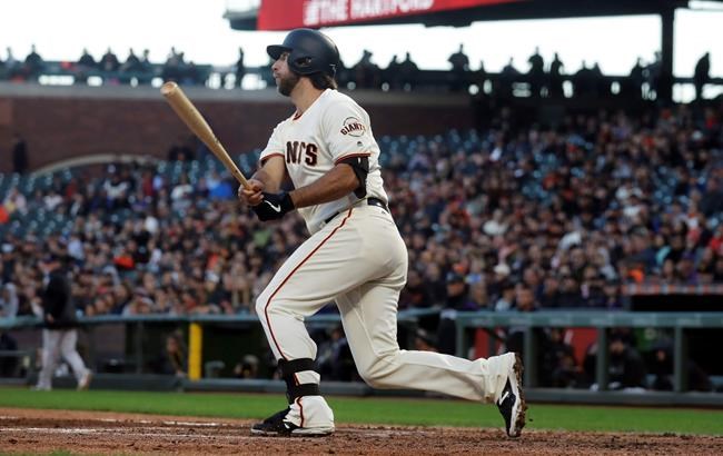 San Francisco Giants' Madison Bumgarner hits an RBI single against the Colorado Rockies during the fourth inning of a baseball game in San Francisco, Tuesday, June 25, 2019. (AP Photo/Jeff Chiu)
