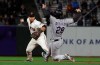 San Francisco Giants shortstop Donovan Solano, left, throws to first base after forcing out Colorado Rockies' Nolan Arenado (28) at second base during the eighth inning of a baseball game in San Francisco, Monday, June 24, 2019. The Rockies' Daniel Murphy was safe at first base. (AP Photo/Jeff Chiu)