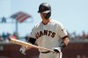 San Francisco Giants' Buster Posey walks to the dugout after striking out against the Colorado Rockies during the fourth inning of a baseball game in San Francisco, Sunday, April 14, 2019. (AP Photo/Jeff Chiu)