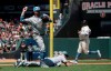 Milwaukee Brewers third baseman Travis Shaw, top left, throws over pitcher Chase Anderson while fielding a bunt by San Francisco Giants' Mike Yastrzemski as Pablo Sandoval, back right, advances to third base during the fifth inning of a baseball game in San Francisco, Sunday, June 16, 2019. Yastrzemski reached first base safely. (AP Photo/Jeff Chiu)