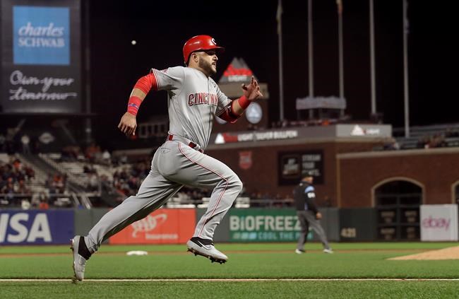 Cincinnati Reds' Eugenio Suarez runs home to score against the San Francisco Giants during the ninth inning of a baseball game in San Francisco, Friday, May 10, 2019. (AP Photo/Jeff Chiu)