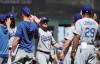 Los Angeles Dodgers' Max Muncy, center, celebrates with teammates after the Dodgers defeated the San Francisco Giants in a baseball game in San Francisco, Sunday, June 9, 2019. (AP Photo/Jeff Chiu)
