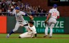Chicago Cubs shortstop Javier Baez, left, throws to first base after forcing out San Francisco Giants' Mike Yastrzemski, center, at second base on a double play hit into by Pablo Sandoval during the fifth inning of a baseball game in San Francisco, Monday, July 22, 2019. Cubs second baseman Robel Garcia (16) looks on. (AP Photo/Jeff Chiu)