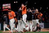 San Francisco Giants relief pitcher Will Smith, front right, celebrates with assistant hitting coach Rick Schu after the Giants defeated the Milwaukee Brewers 5-3 in a baseball game in San Francisco, Friday, June 14, 2019. (AP Photo/Jeff Chiu)