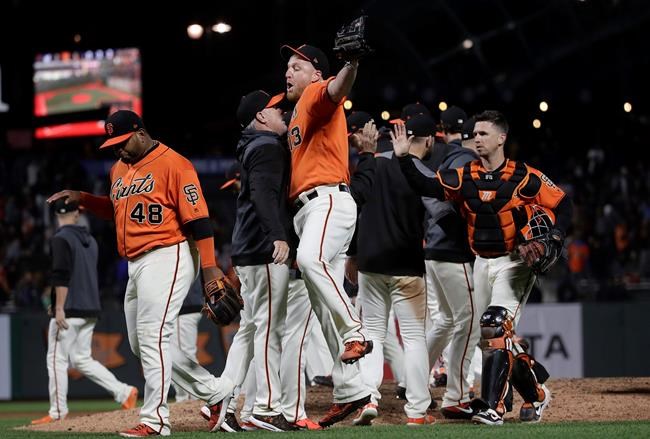 San Francisco Giants relief pitcher Will Smith, front right, celebrates with assistant hitting coach Rick Schu after the Giants defeated the Milwaukee Brewers 5-3 in a baseball game in San Francisco, Friday, June 14, 2019. (AP Photo/Jeff Chiu)