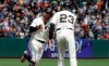 San Francisco Giants' Evan Longoria, left, is congratulated by third base coach Ron Wotus (23) after hitting a solo home run against the St. Louis Cardinals during the seventh inning of a baseball game in San Francisco, Sunday, July 7, 2019. (AP Photo/Jeff Chiu)