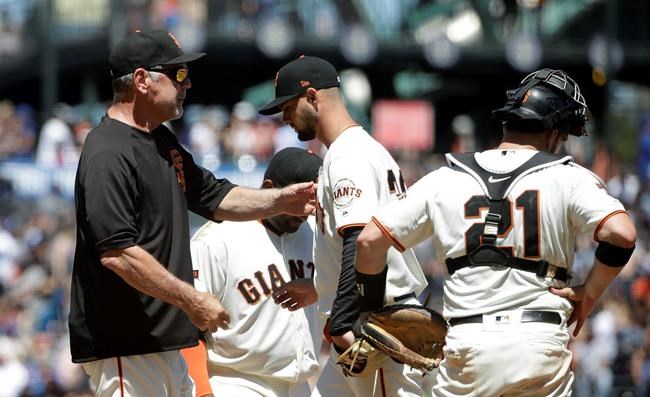 San Francisco Giants pitcher Tyler Beede, center, hands the ball to manager Bruce Bochy, left, as he is relieved during the sixth inning of a baseball game against the Chicago Cubs in San Francisco, Wednesday, July 24, 2019. Also pictured at right is catcher Stephen Vogt. (AP Photo/Jeff Chiu)