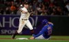 San Francisco Giants second baseman Joe Panik, left, throws to first base after forcing Chicago Cubs' David Bote (13) at second base on a double play hit by Addison Russell during the ninth inning of a baseball game in San Francisco, Tuesday, July 23, 2019. (AP Photo/Jeff Chiu)