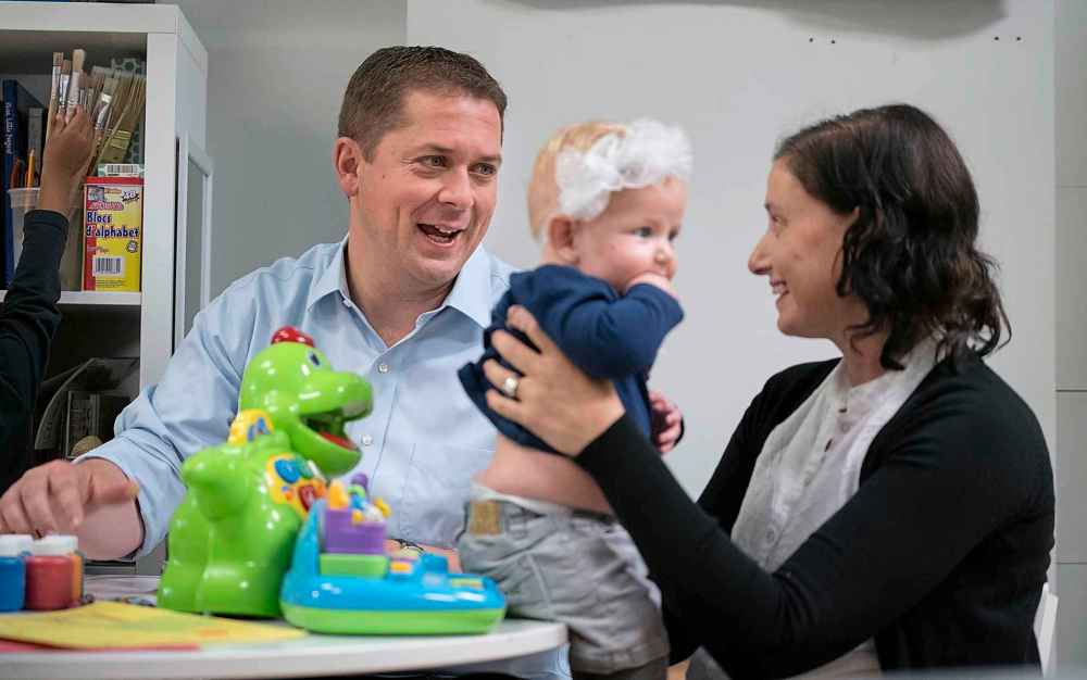 Paul Chiasson / The Canadian Press
Conservative leader Andrew Scheer chats with a mother holding her child while visiting a daycare in Toronto, on Thursday.