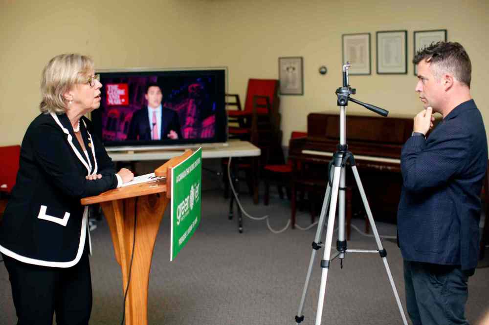 CP
Twitter Canada, Steve Ladurantaye, records Green Party leader Elizabeth May, on his smart phone, to be uploaded to Twitter as she live-tweets to leaders during the Globe and Mail leaders' debate, in Victoria, B.C., on Thursday, September 17, 2015. The Green party leader wasn't invited to the Calgary event hosted by the Globe and Mail newspaper, but she's using Twitter to try to elbow her way into the conversation. THE CANADIAN PRESS/Chad Hipolito