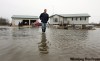 Ruth Bonneville /WInnipeg Free Press  
Roger Trueman of Peltz Road in St. Clements walks down his driveway through more than a foot of water on Sunday morning. He was up  all night pumping water out of his basement after a ice jam caused flooding.
